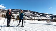 man and women cross country skiing