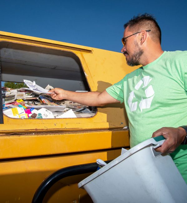 man recycling paper