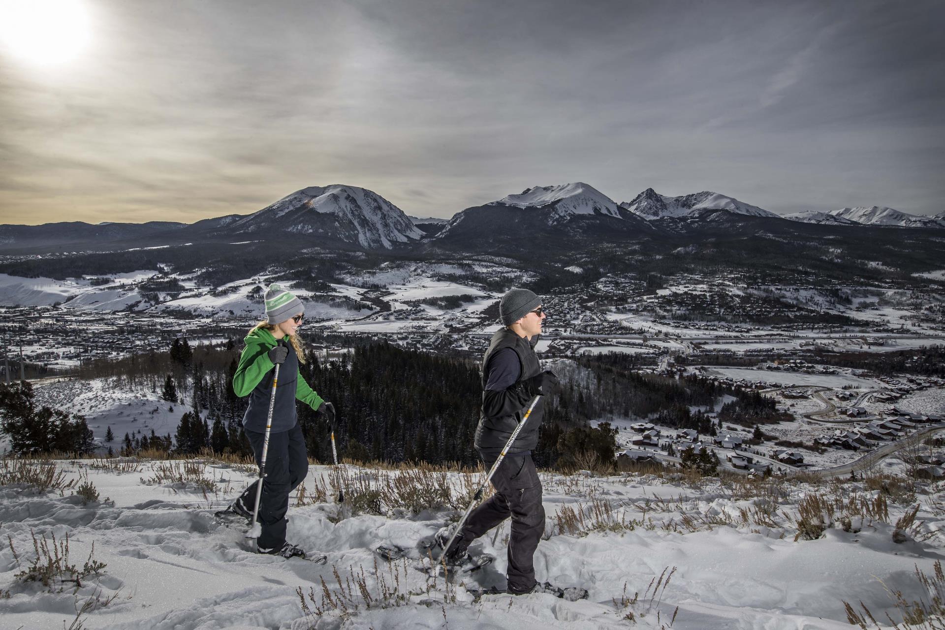 man and woman snowshoeing